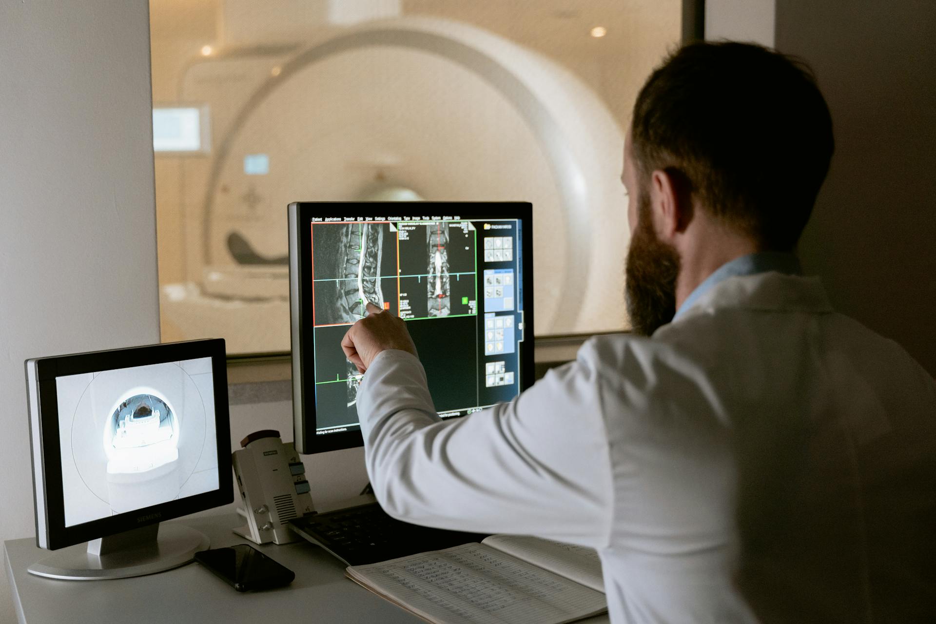 Medical professional analyzing MRI scan results with medical imaging equipment